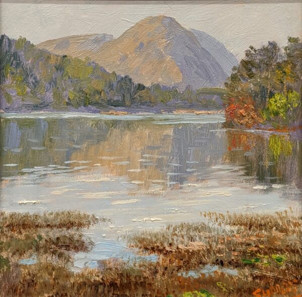 Grasmere oil painting by Lake District artist Jeff Sudders showing Helm Crag reflected in the lake a hint of autumnal colours in the trees