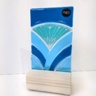 Inspired by the iconic Lotus flower this standing sun catcher is made using rich expressive blue and turquois coloured glass and finished with delicate hand-painted details.