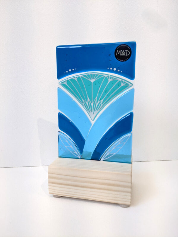 Inspired by the iconic Lotus flower this standing sun catcher is made using rich expressive blue and turquois coloured glass and finished with delicate hand-painted details.