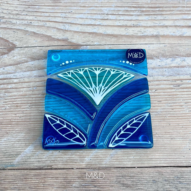 Lotus coaster Inspired by the iconic Lotus flower this handmade coaster is made using rich expressive blue and turquoise coloured glass and finished with delicate hand-painted details.