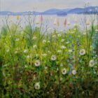 A vibrant summer meadow filled with wildflowers leading down to a peaceful lake with colourful sailing boats. A small island sits on the water, framed by rolling blue hills under a soft, misty sky.