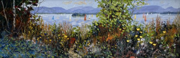 Derwentwater with colourful sailing boats, distant fells, and a foreground of wild grasses, shrubs, and yellow wildflowers viewed from the lakeshore