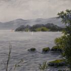 A misty lake with sailing boats, wooded islands, mountains and trees along the shore.
