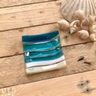 This beautiful trinket fused glass dish is made using colours of the sand and sea with additional hand-painted details made by Mother Daughter glass.