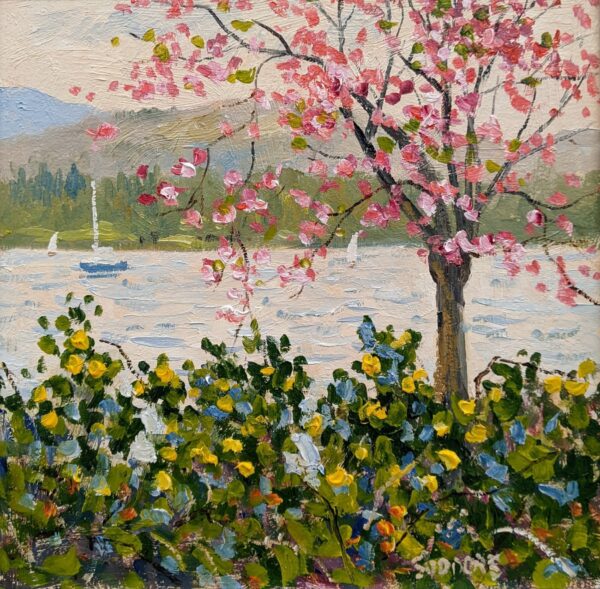 Oil painting of a flowering pink tree beside a lake, with colorful flowers in the foreground.